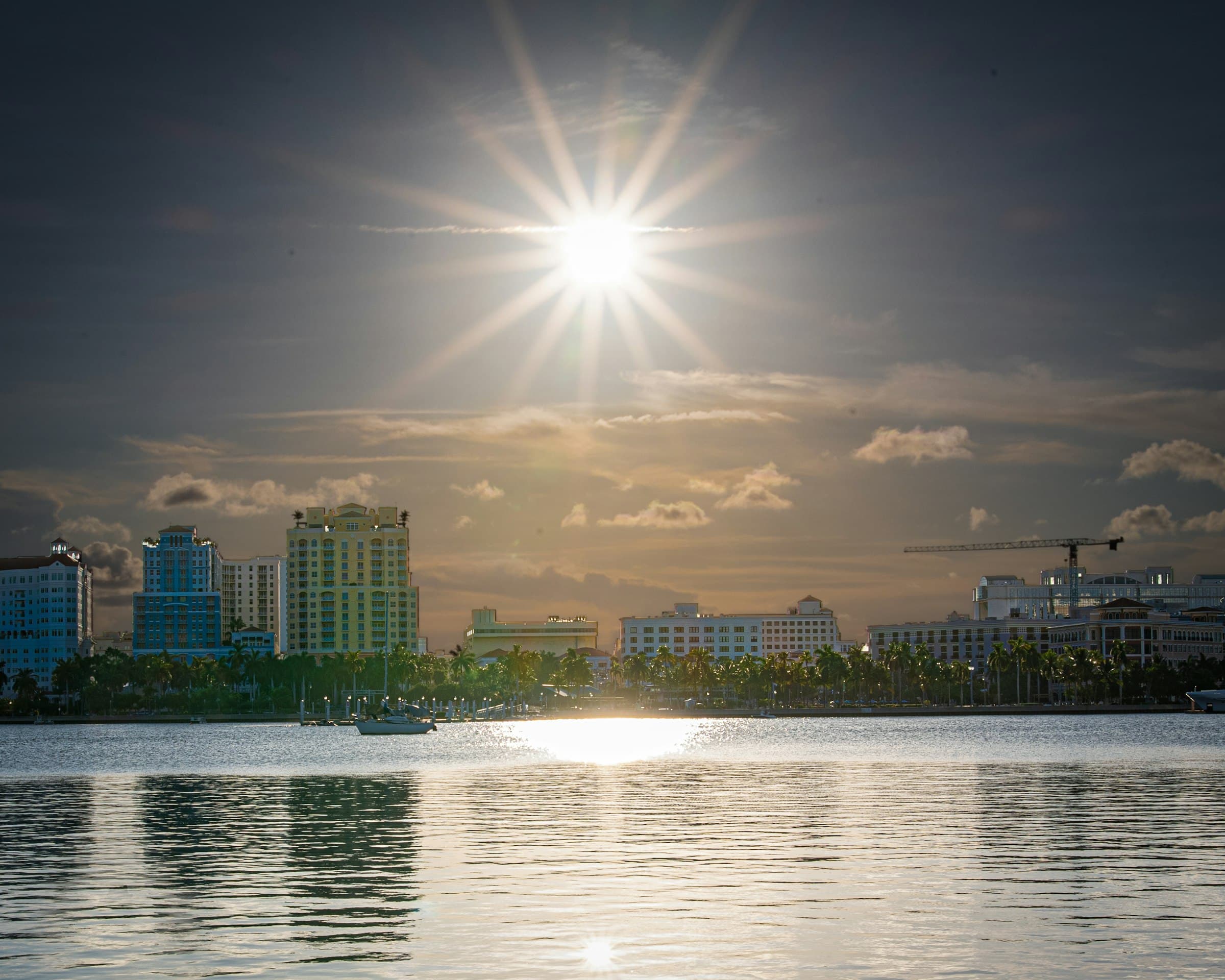 West Palm Beach skyline at sunrise across the calm Intracoastal Waterway